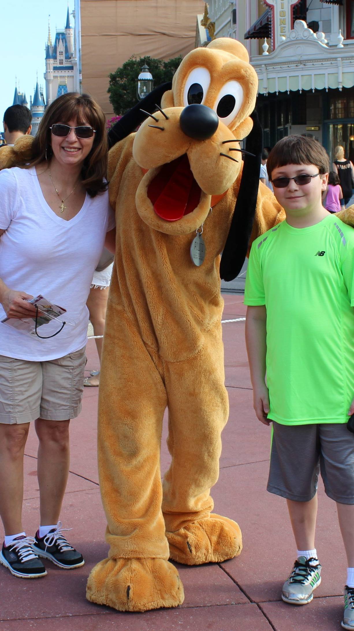 woman and a child posing with the Disney character 